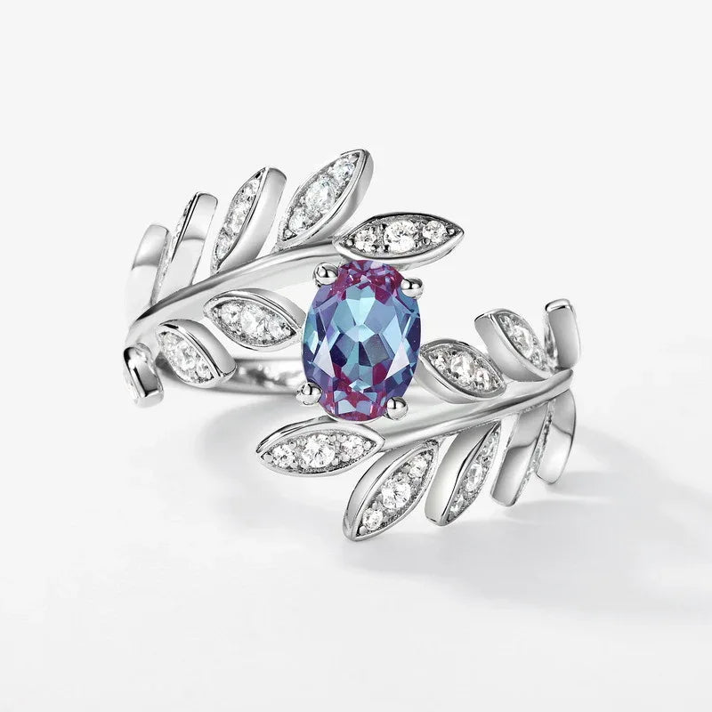 Oval Alexandrite leaf wrap ring with clear accents, center stone close-up on a white background