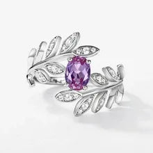 Oval Alexandrite leaf wrap ring with clear accents, pink-toned Alexandrite view under alternate lighting