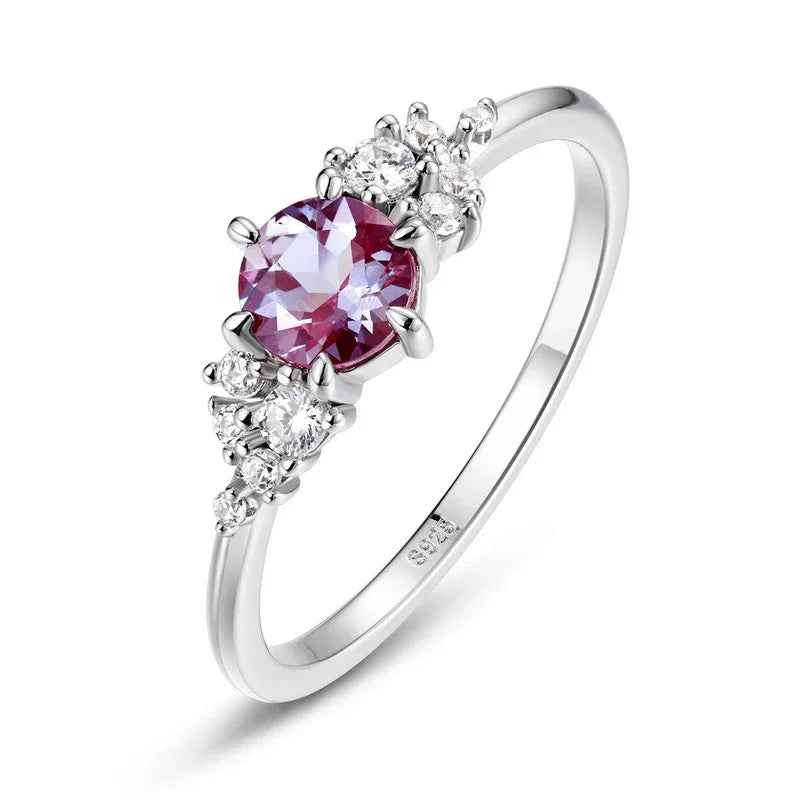 Oval Alexandrite ring with clear-stone side clusters, pink-toned Alexandrite view under alternate lighting
