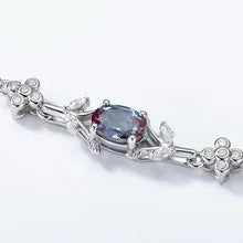 Oval Alexandrite station bracelet with clear accents, close-up showing the setting and decorative accents