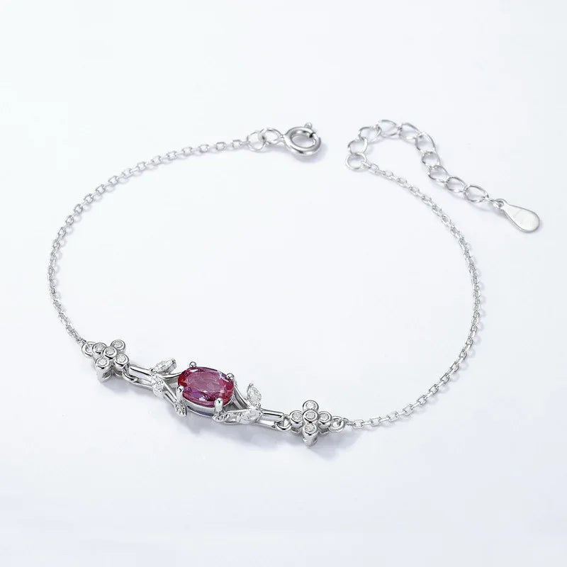 Oval Alexandrite station bracelet with clear accents, pink-toned Alexandrite view under alternate lighting