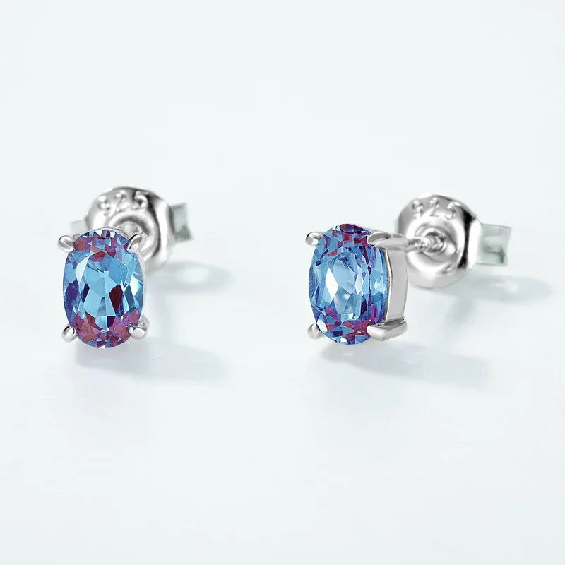 Oval Alexandrite stud earrings, center stone close-up on a white background