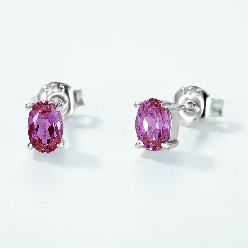 Oval Alexandrite stud earrings, pink-toned Alexandrite view under alternate lighting