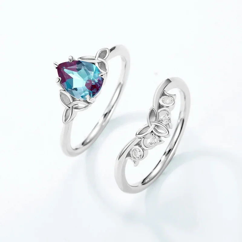 Oval Alexandrite three-band ring with leaf and clear-stone accents, separated ring set shown on a white background
