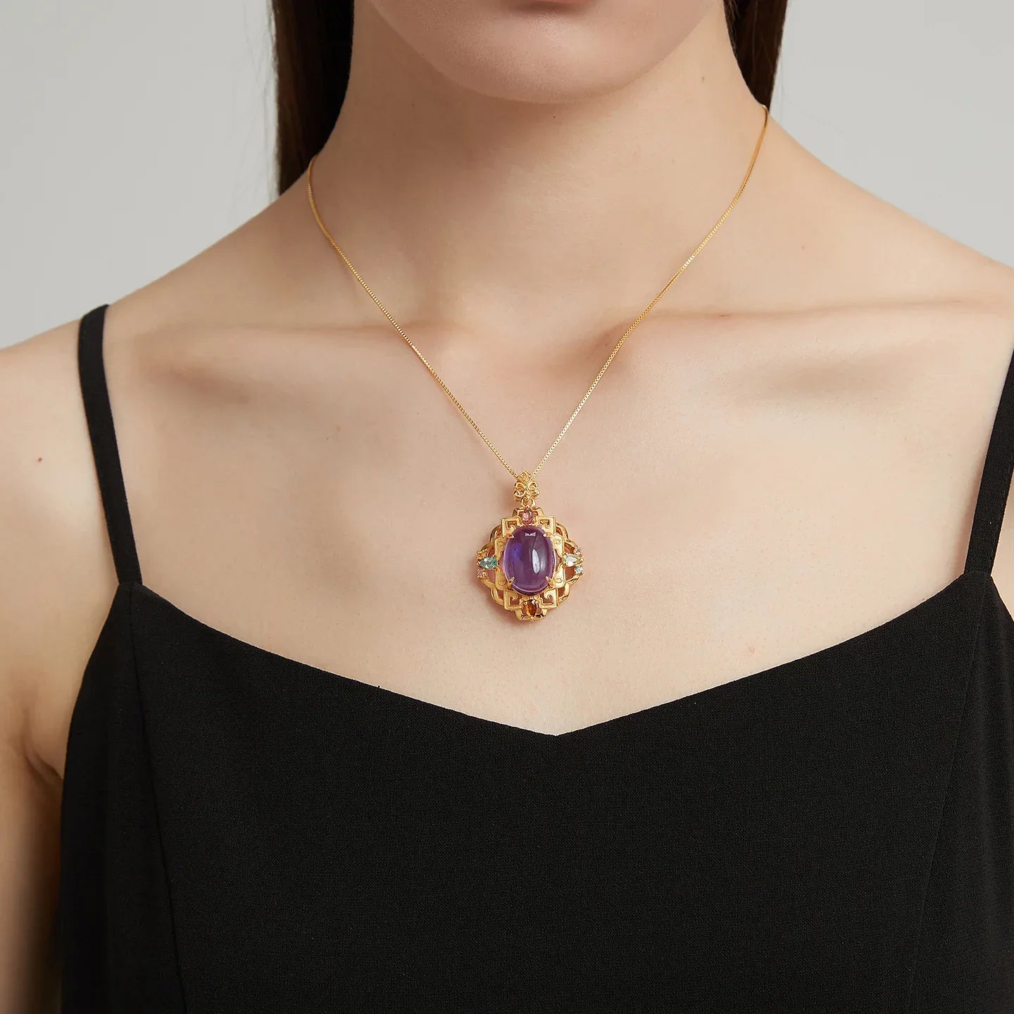 oval amethyst filigree pendant necklace worn at the neckline in a portrait
