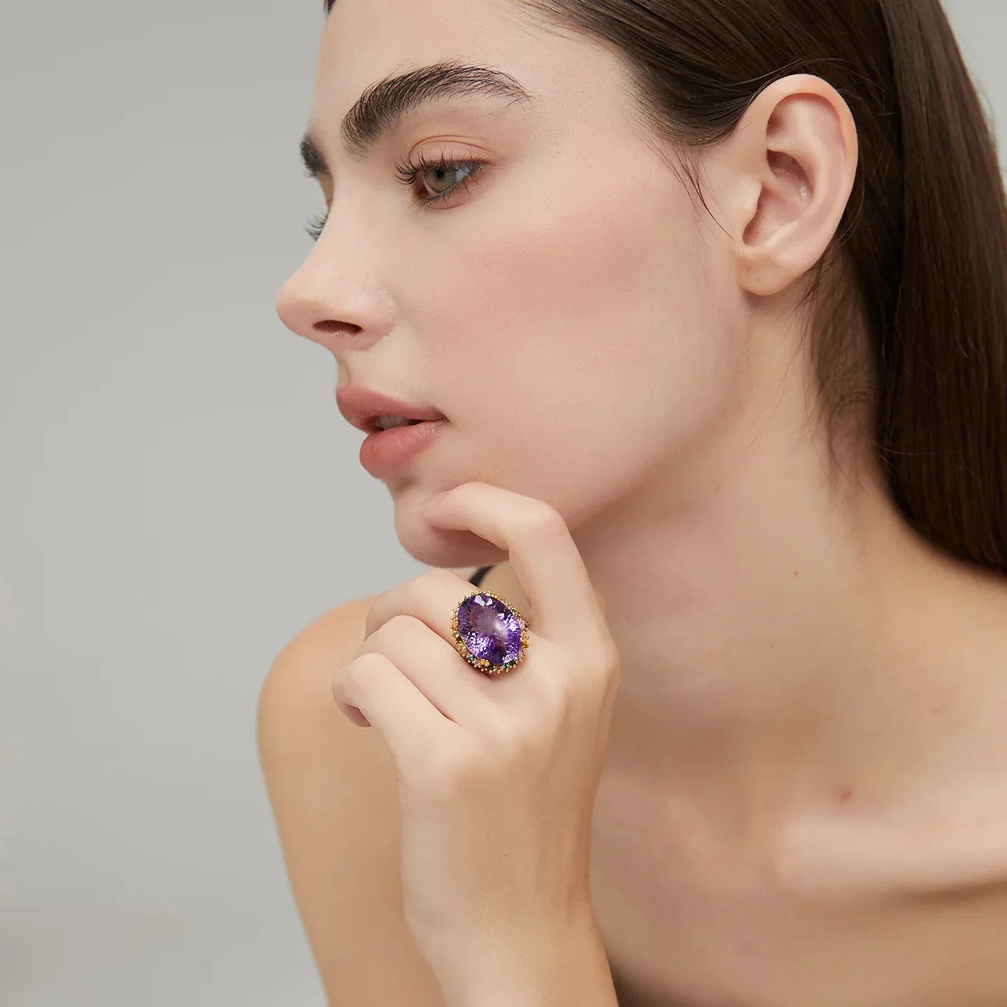 oval amethyst multigem ring worn detail beside the face