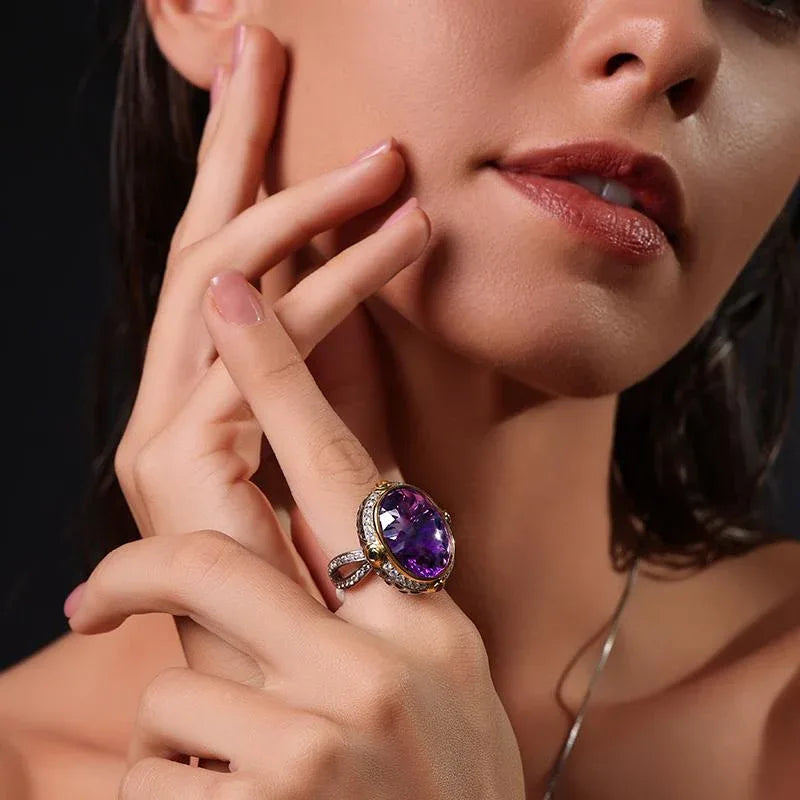 oval amethyst multigem ring worn on the hand in a close-up