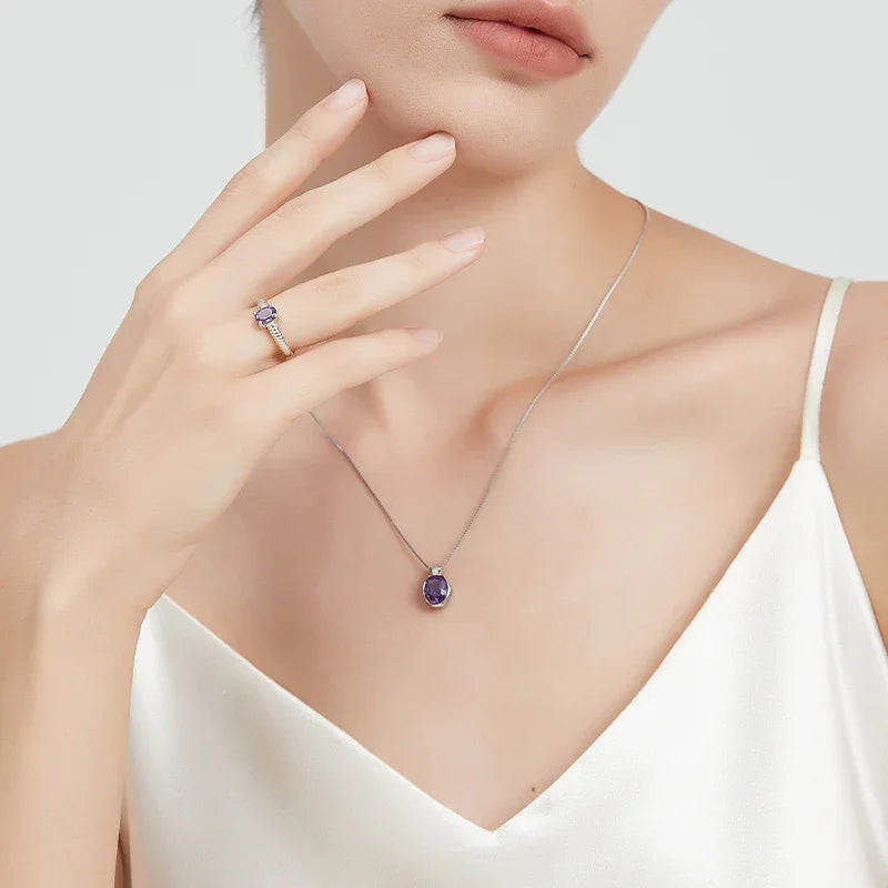 oval amethyst pendant necklace worn at the neckline in a close-up
