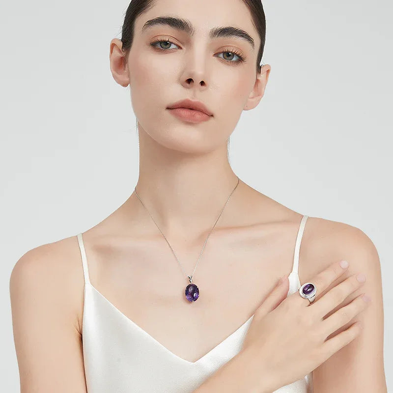 oval amethyst wide-band ring styled portrait showing the ring for scale