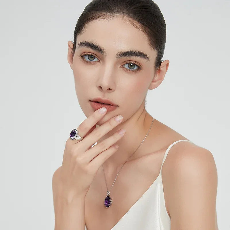 oval amethyst wide-band ring worn detail beside the face