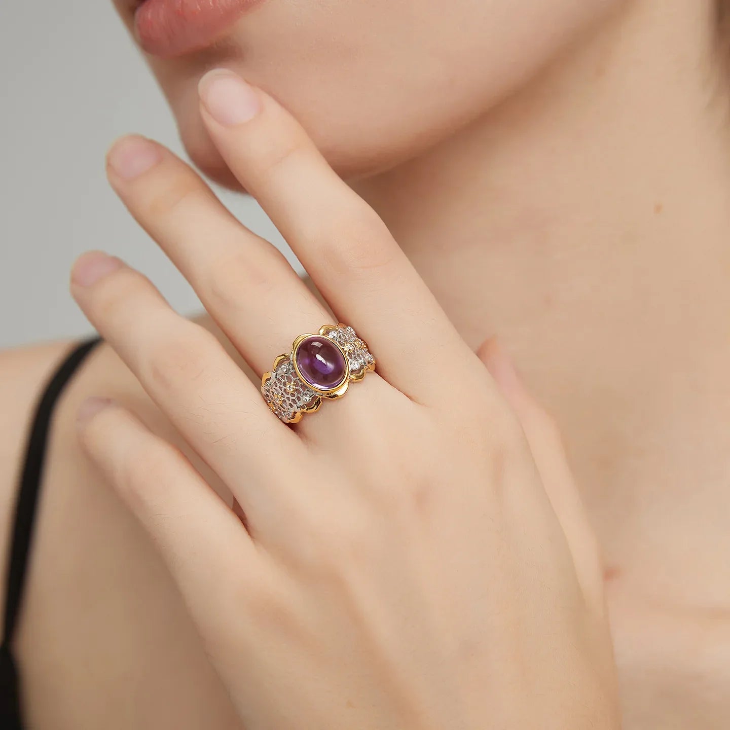oval amethyst filigree ring worn on the hand from a second angle