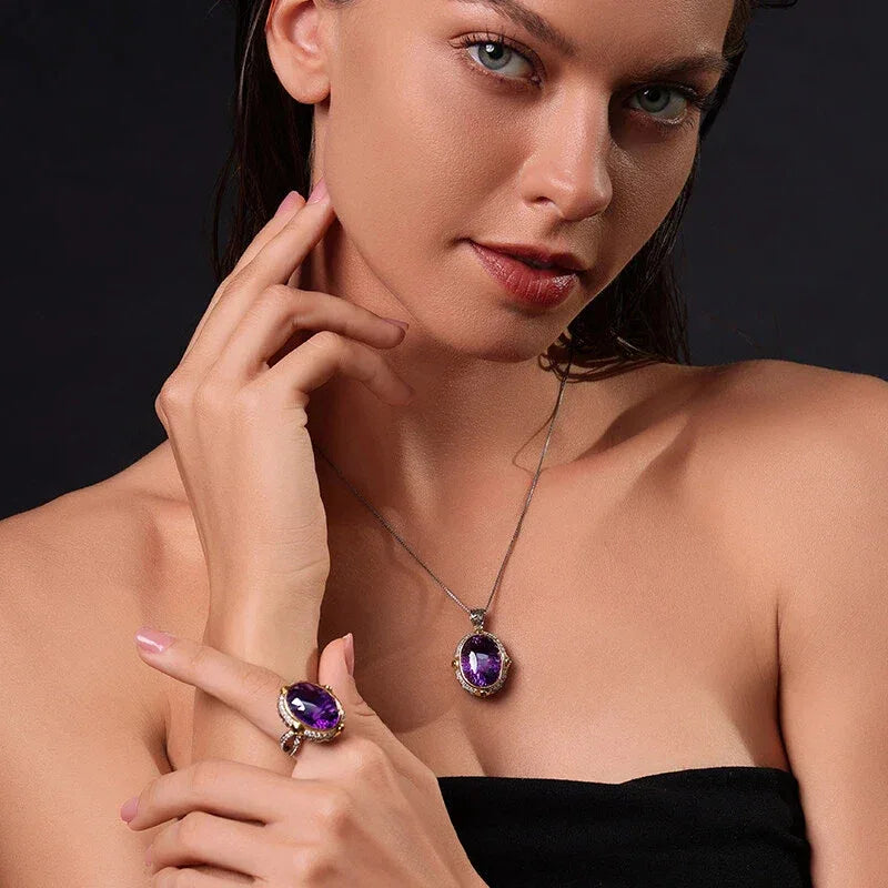 oval amethyst halo pendant necklace worn at the neckline in a close-up