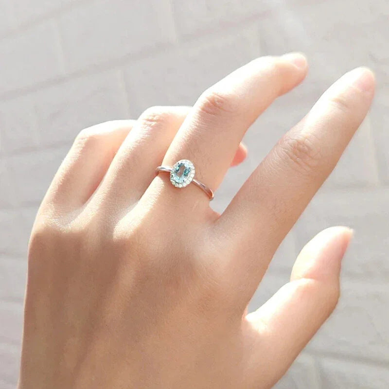 Oval Aquamarine Bezel-Set Ring worn on the hand in a close-up