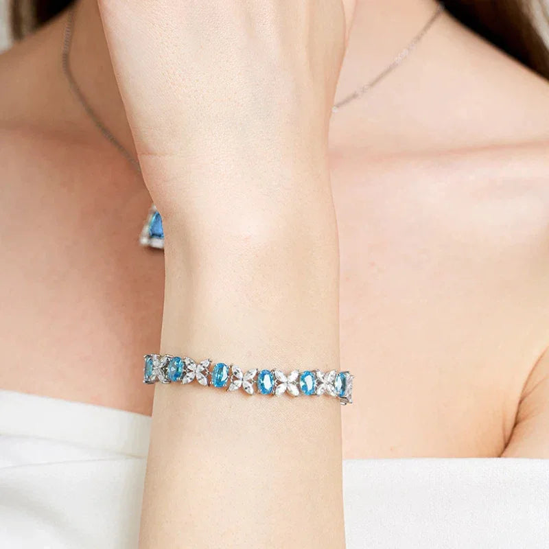 Oval Aquamarine Butterfly-Link Bracelet worn on the wrist in a close-up