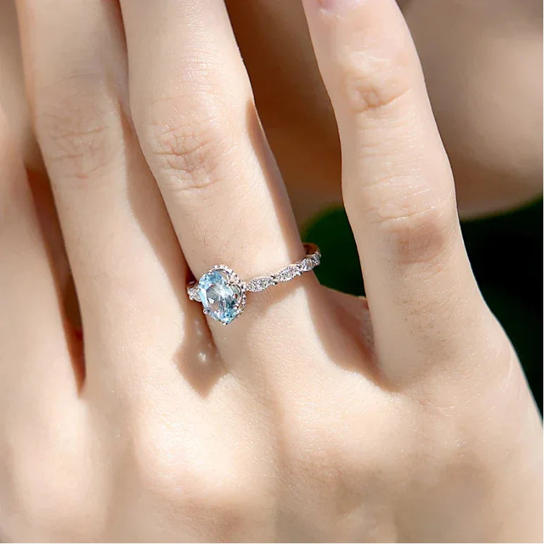 Oval Aquamarine Crown Accent Ring worn on the hand from a second angle