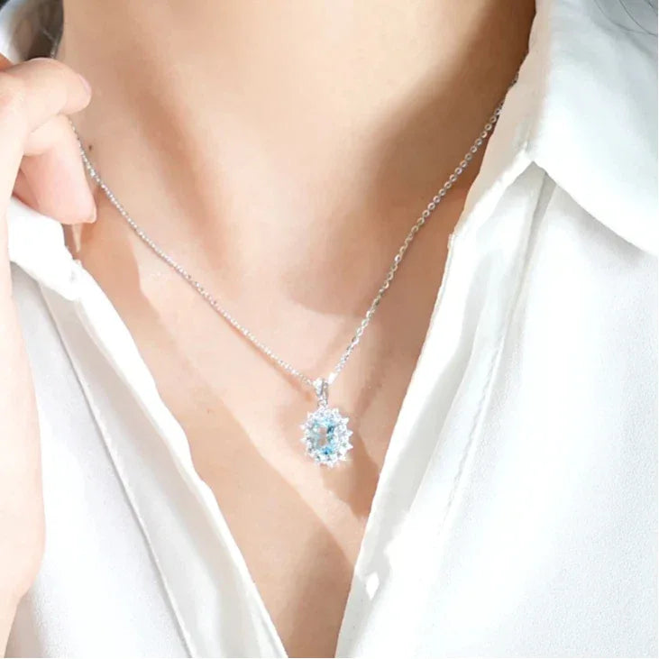 Oval Aquamarine Halo Pendant Necklace styled neckline view showing pendant scale
