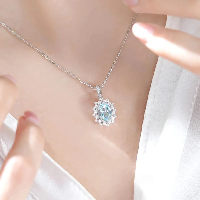 Oval Aquamarine Halo Pendant Necklace worn at the neckline from a second angle