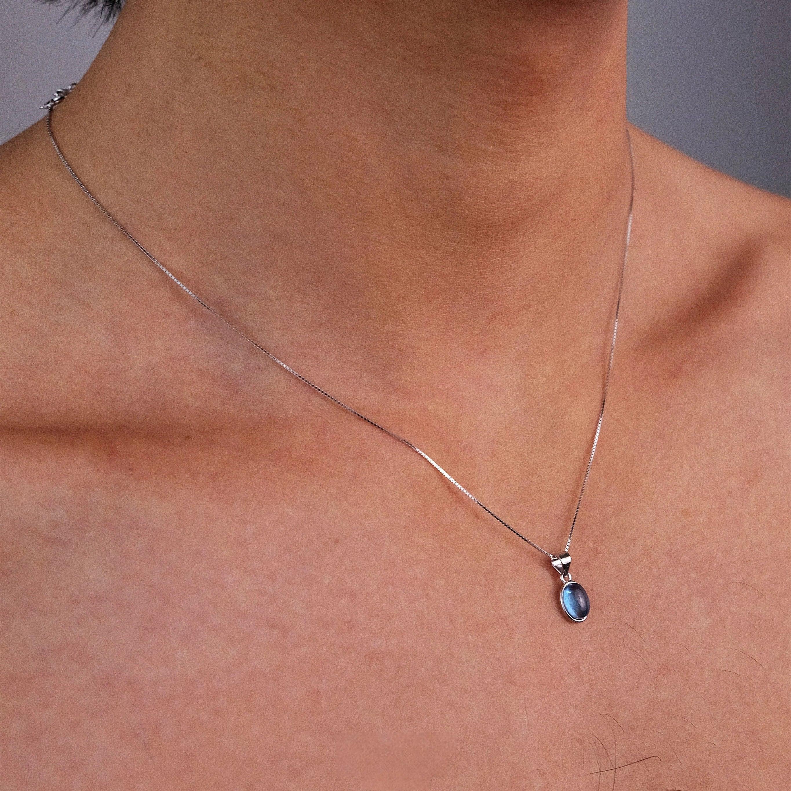 Oval Aquamarine Snake Chain Pendant Necklace worn at the neckline from a second angle