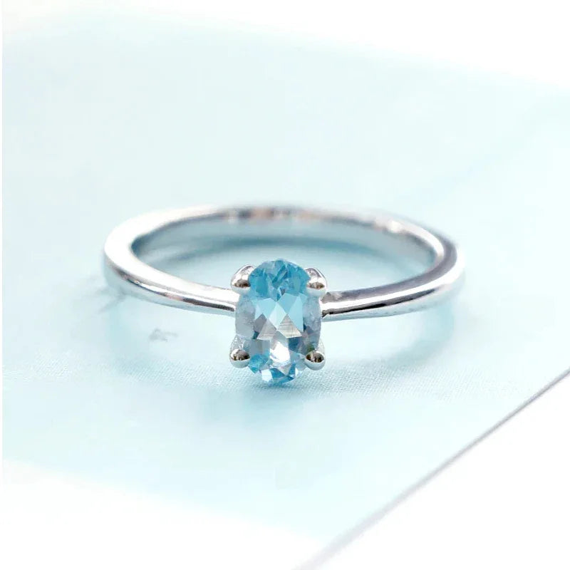 Oval Aquamarine Solitaire Ring worn on the hand in a close-up