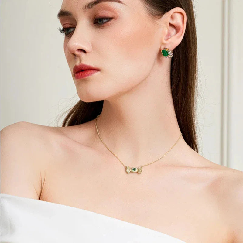 Oval Emerald Butterfly Necklace worn at the neckline from a second angle
