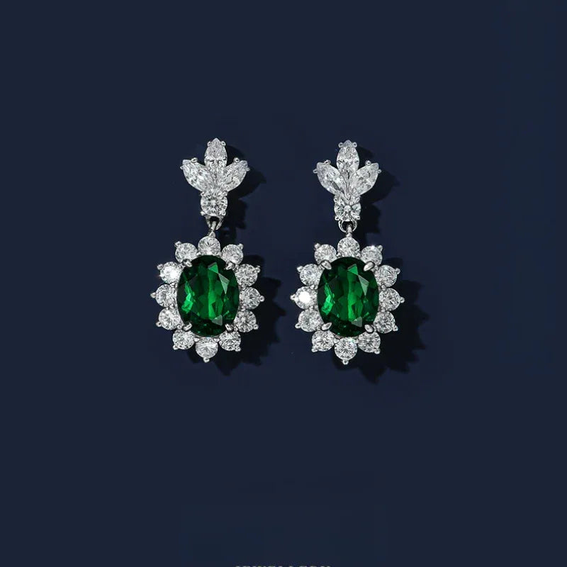 Oval Emerald Floral Drop Earrings paired product view on a dark background