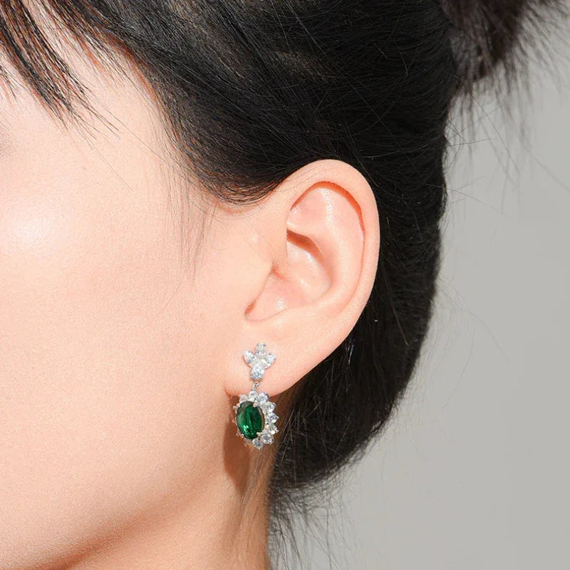 Oval Emerald Floral Drop Earrings styled ear view showing scale