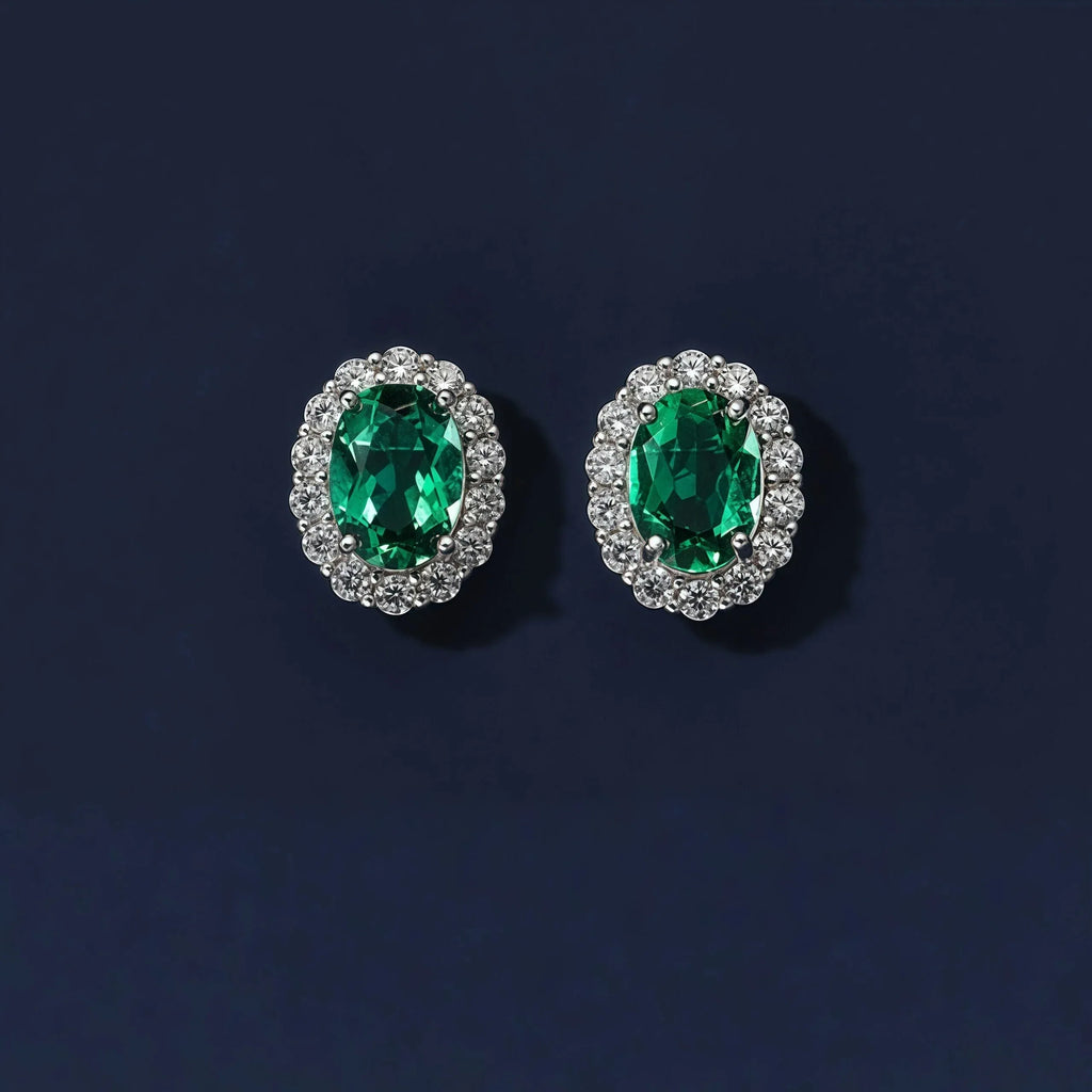 Oval Emerald Halo Stud Earrings paired product view on a dark background