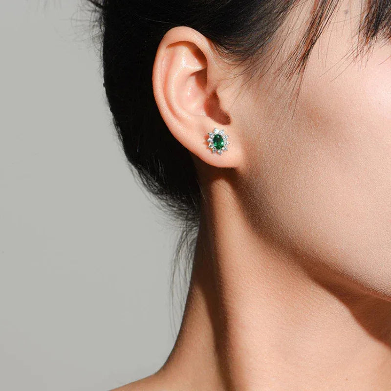 Oval Emerald Sunflower Stud Earrings styled ear view showing scale
