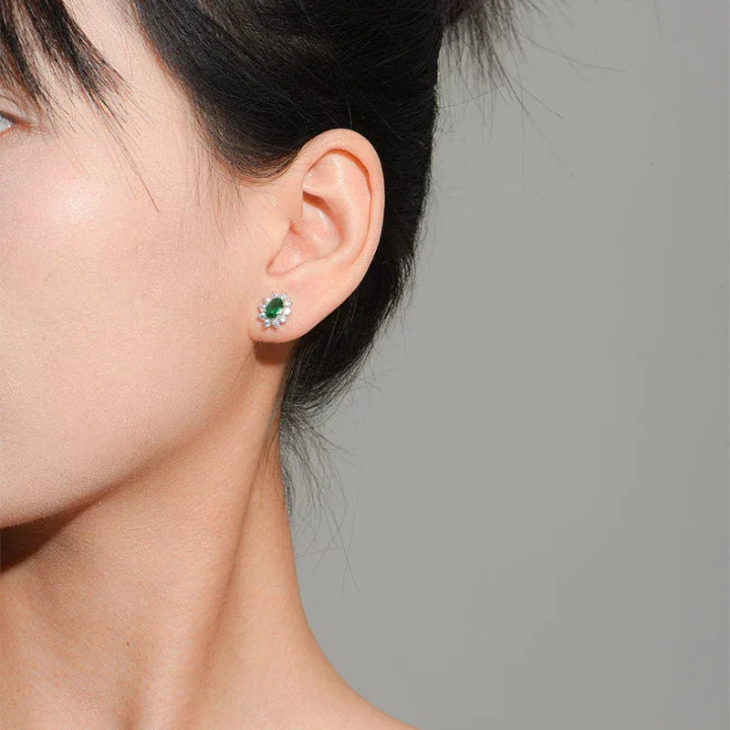 Oval Emerald Sunflower Stud Earrings worn on the ear from a second angle
