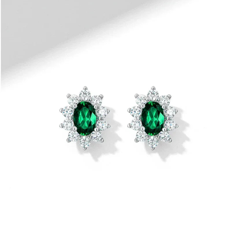 Oval Emerald Sunflower Stud Earrings worn on the ear in a close-up