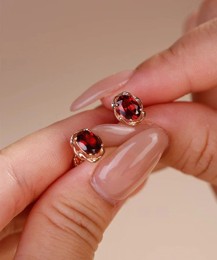 Oval Garnet Bezel Stud Earrings angled product detail on a jewelry display