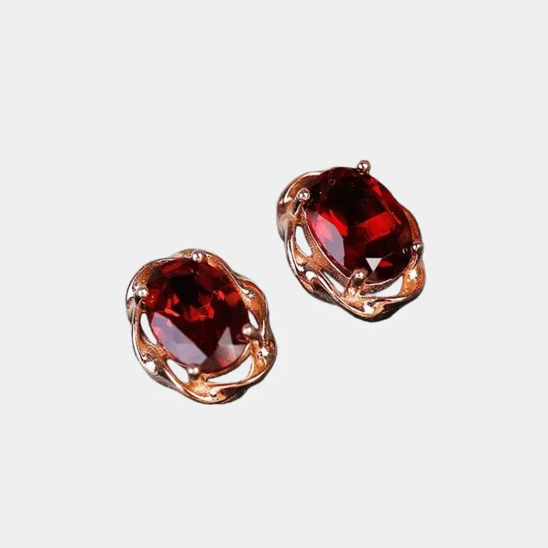 Oval Garnet Bezel Stud Earrings front product view on a light background