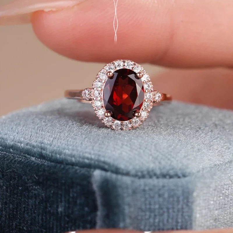 Oval Garnet Halo Adjustable Ring angled product detail on a jewelry display