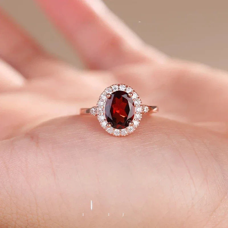 Oval Garnet Halo Adjustable Ring worn on the hand from a second angle