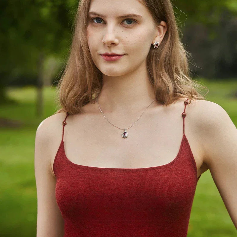 Oval Garnet Ornate Pendant Necklace worn at the neckline from a second angle