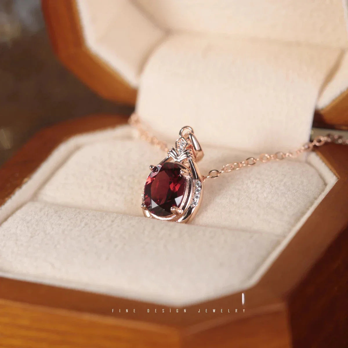 Oval Garnet Teardrop Pendant Necklace pendant styled on a jewelry display