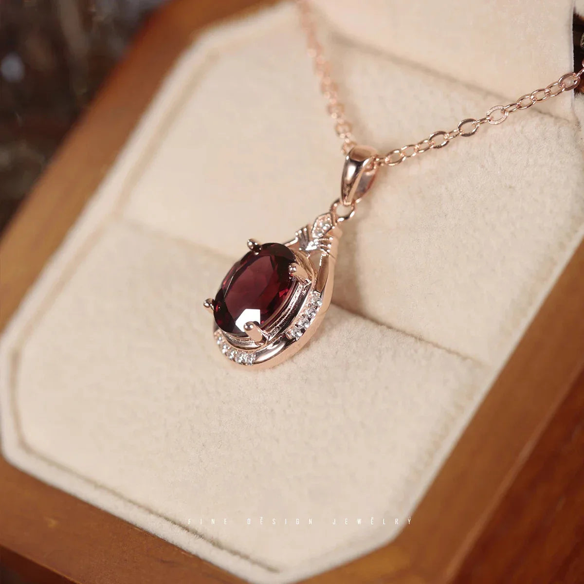 Oval Garnet Teardrop Pendant Necklace worn at the neckline from a second angle