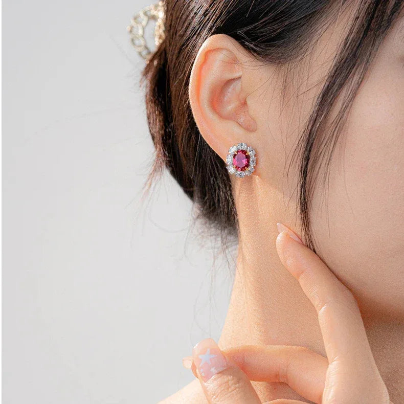 Oval Ruby Halo Stud Earrings — earrings worn on ear