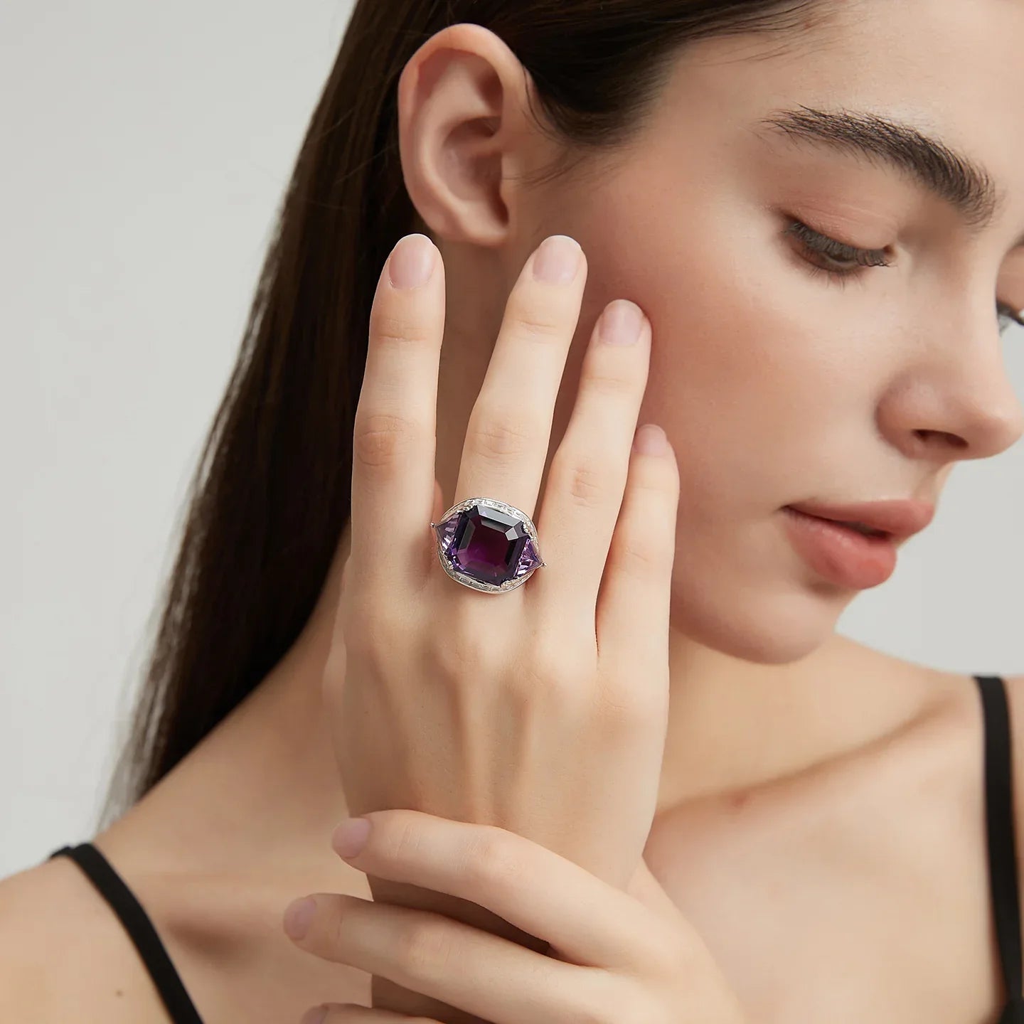 oversized amethyst open ring worn detail beside the face