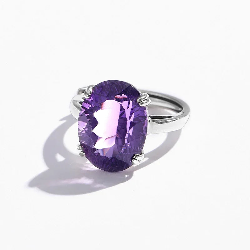 oversized oval amethyst ring worn detail beside the face