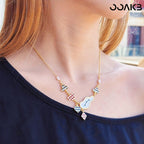 Model wearing the Alice-inspired clock necklace, featuring whimsical black-white squares and red hearts—ideal for a paper wedding gift with customizable charm.