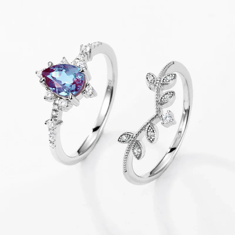 Pear-cut Alexandrite vine stack ring with leaf accents, separated ring set shown on a white background