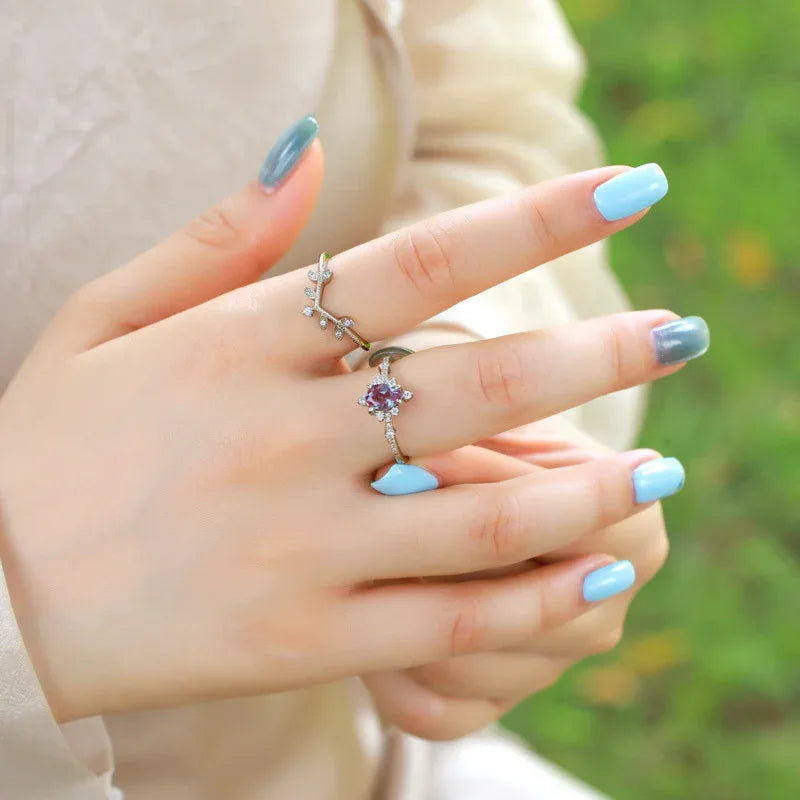 Pear-cut Alexandrite vine stack ring with leaf accents, shown worn in a close lifestyle view