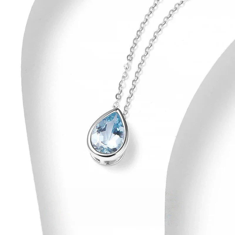 Pear-Cut Aquamarine Bezel Pendant Necklace pendant and chain detail on a light background