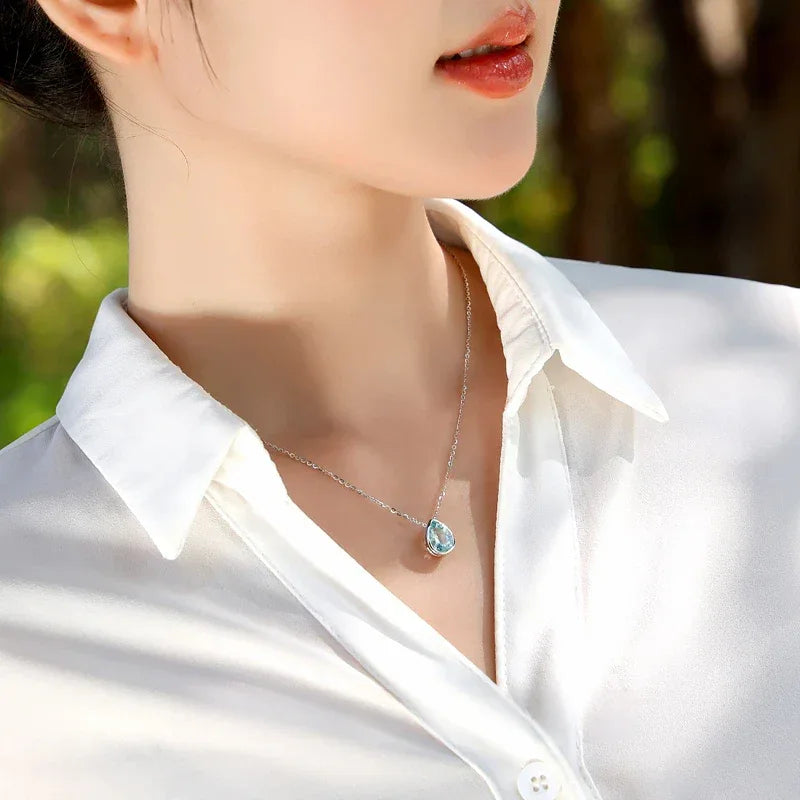 Pear-Cut Aquamarine Bezel Pendant Necklace styled neckline view showing pendant scale