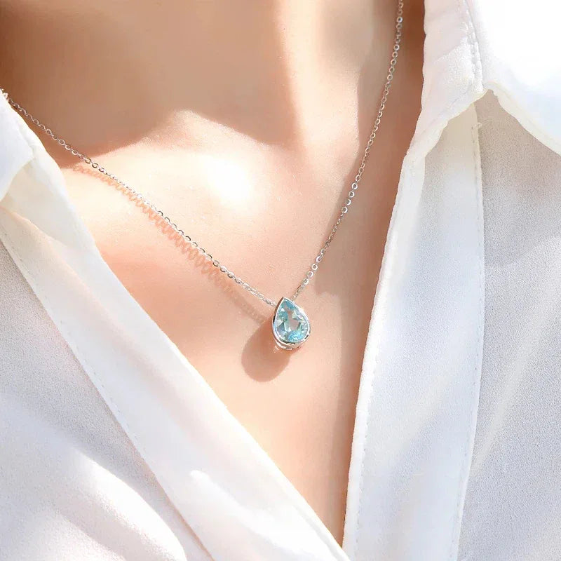 Pear-Cut Aquamarine Bezel Pendant Necklace worn at the neckline from a second angle