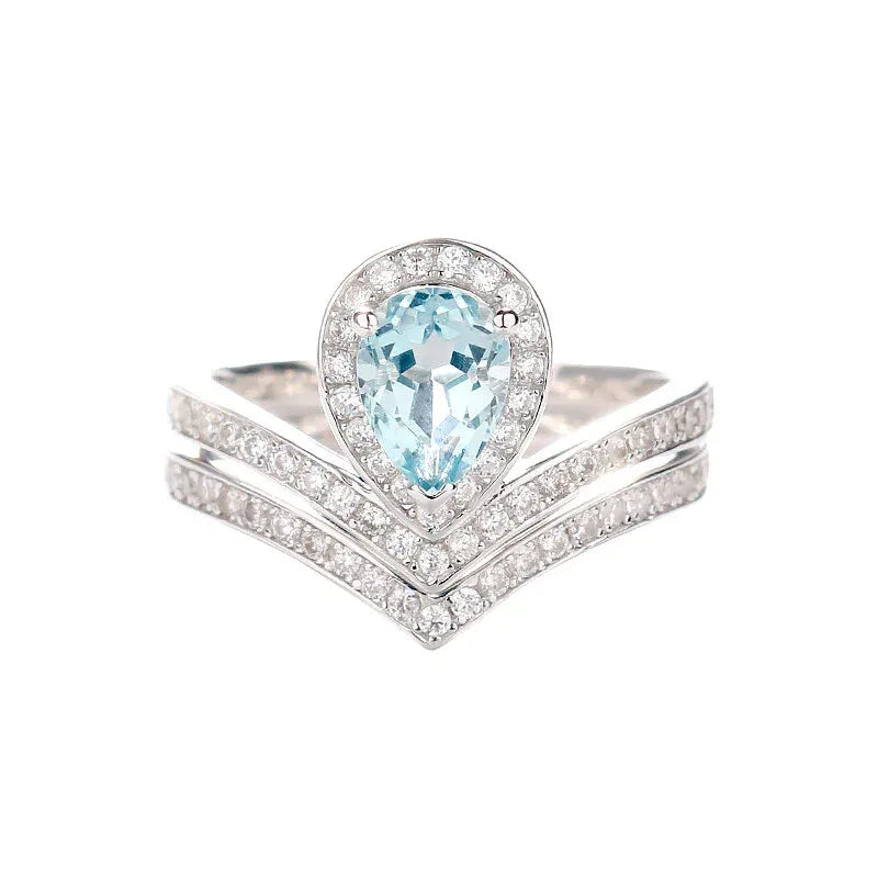 Pear-Cut Aquamarine Crown Stack Ring worn on the hand in a close-up