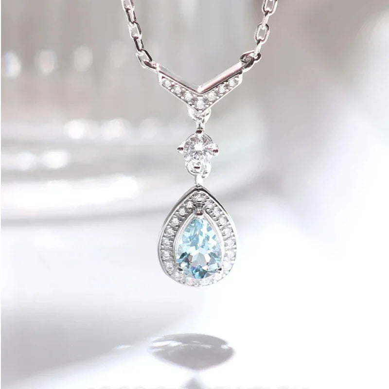 Pear-Cut Aquamarine Halo Drop Necklace angled pendant detail on white