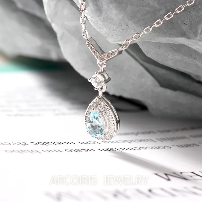 Pear-Cut Aquamarine Halo Drop Necklace styled neckline view showing pendant scale