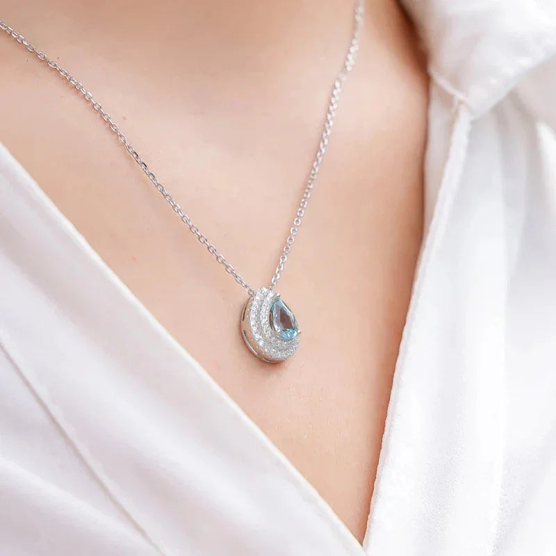 Pear-Cut Aquamarine Halo Pendant Necklace styled neckline view showing pendant scale